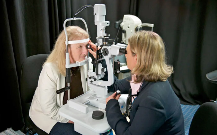Penny Allen examines Dianne Ashworth's eyes